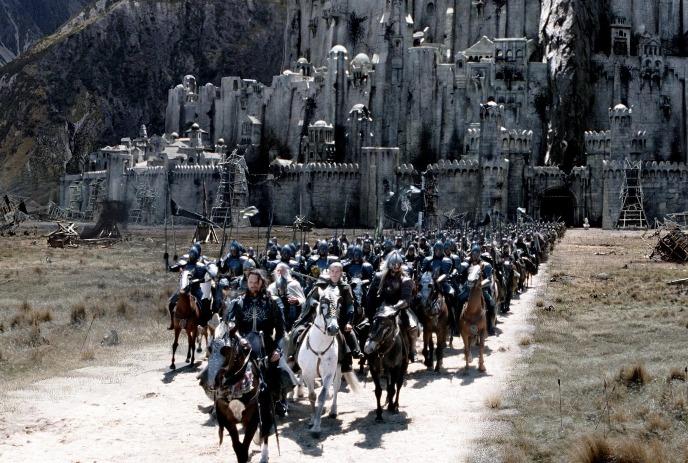 Large group of people on horseback racing towards the camera.