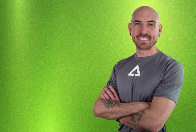 Keynote speaker Trent Burke standing in front of a green screen.