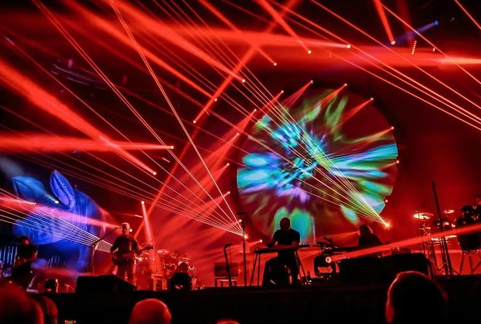 The musical group Brit Floyd performing live on stage in front of a large audience