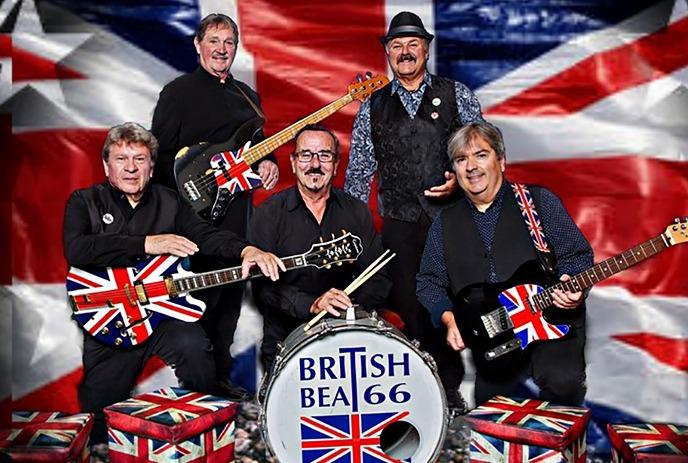 Five band members standing with their instruments in front of a union jack flag.