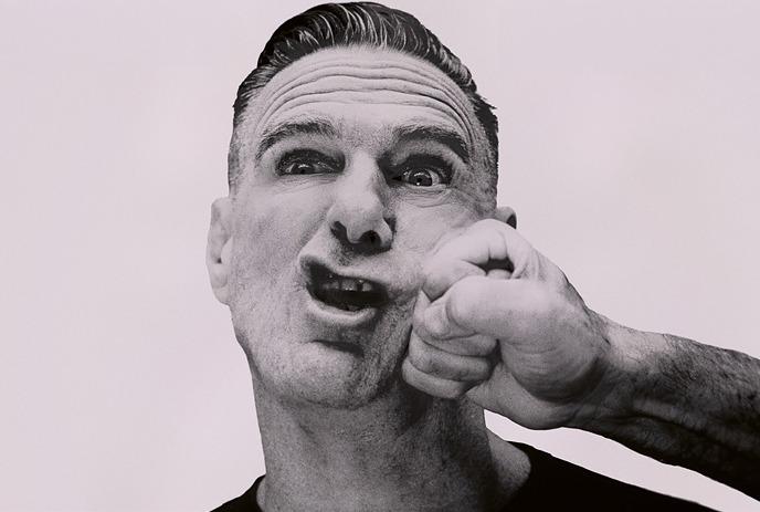 Bryan Adams being punched in the face by a clenched fist.