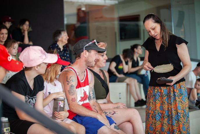 An Indigenous elder shares a ceremony with families gathered at the museum during Canada Day celebrations.
