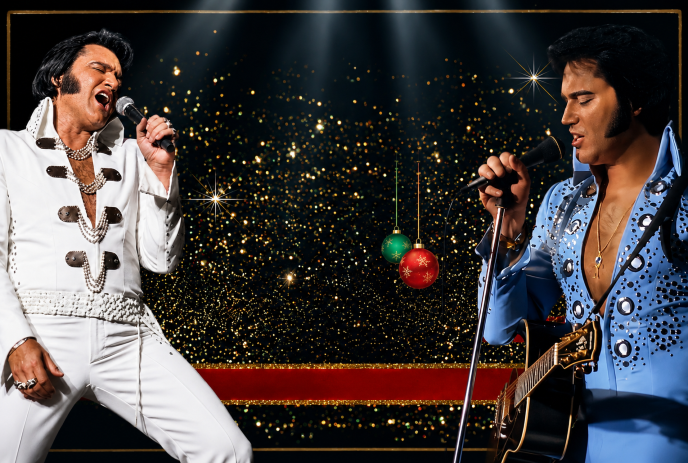 Two performers in Elvis style outfits singing on stage with guitar and festive sparkling background.