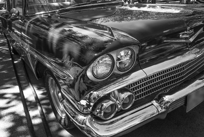 Close-up of a classic Chevrolet car in black and white.