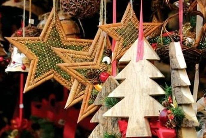 Handmade holiday tree and star ornaments hanging from a tree.
