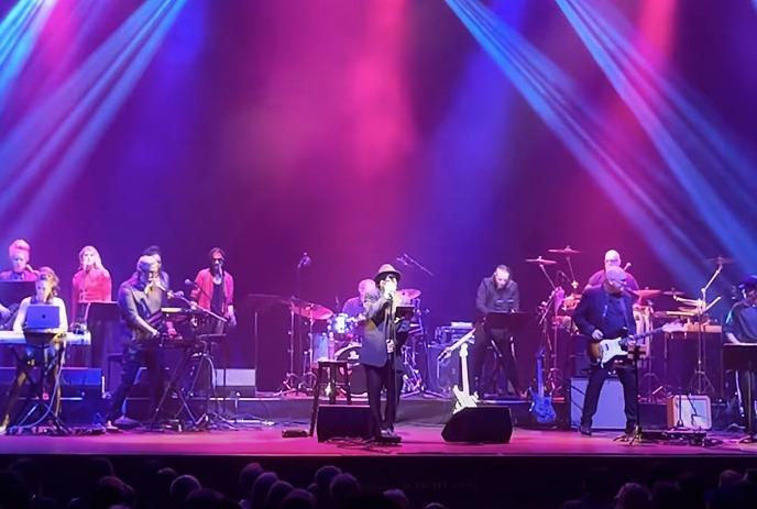 Classic Albums Live performs on stage with dramatic lighting.