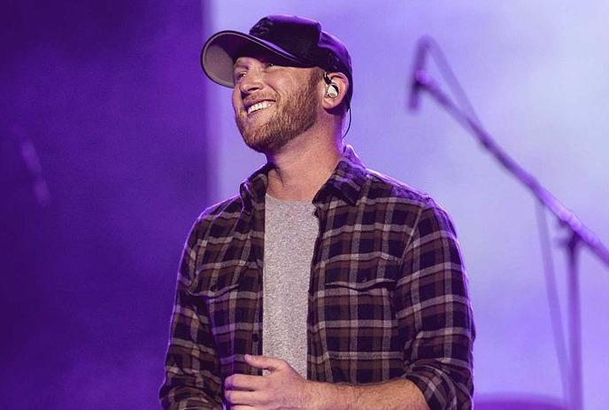 Country musician Cole Swindell performing live on stage