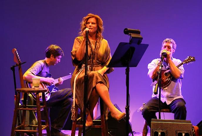 Members of the Cowboy Junkies band performing live on stage.