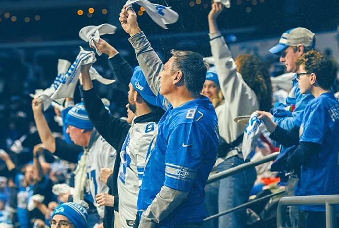 Fans in blue cheer, wave towels, and rally together in a stadium filled with team spirit and excitement.