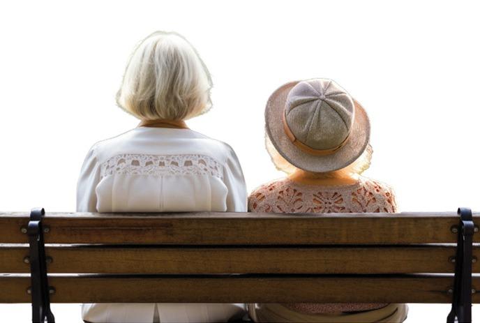 Two people sitting on a bench together.