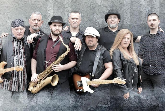 Eight members of the band Duke Street Kings posing together against a textured gray background.