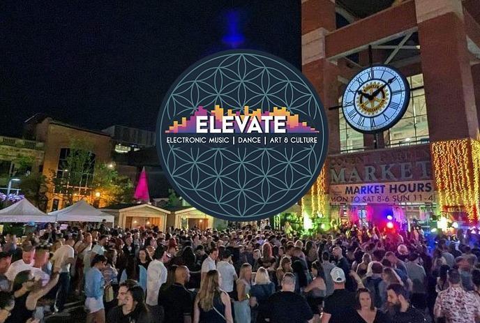 Covent Garden Market lit up with colours at night, with a crowd out front enjoying a previous Elevate Music Festival.