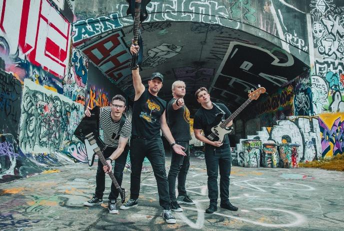 Faber Drive poses energetically in a graffiti-covered tunnel, each member holding an instrument.