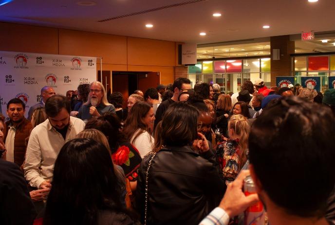 A diverse crowd of attendees mingles and networks at the Forest City Film Festival reception