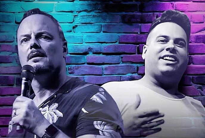 Frank Spadone and Cosimo Tucci perform onstage against a brick wall backdrop with blue and pink lights.