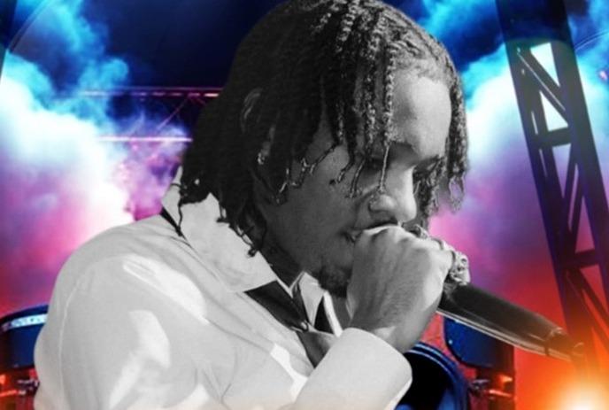 Fresco Trey performs in a white shirt on a vibrant stage with colorful lights, smoke, and speakers.