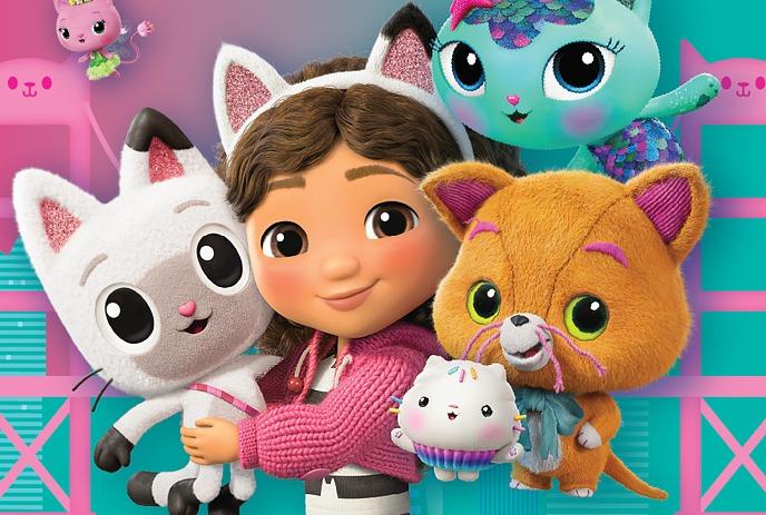 A cartoon character holding a number of cats, with a colourful bridge behind them.