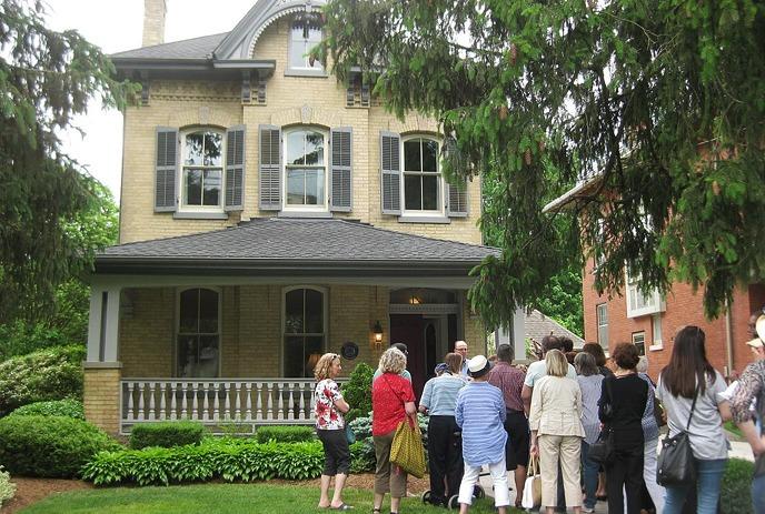 A group of people on the Geranium Heritage House Tour