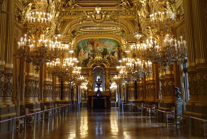 Golden halls gleam, chandeliers glow, art and grandeur flow.