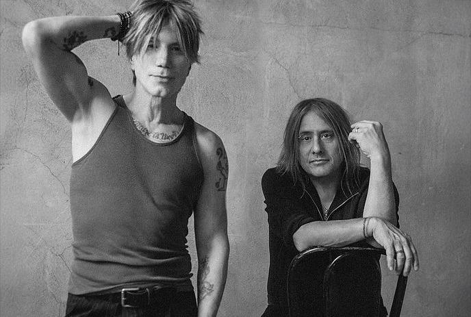 A black and white photo of John Rzeznik and Robby Takac, posing for the camera.