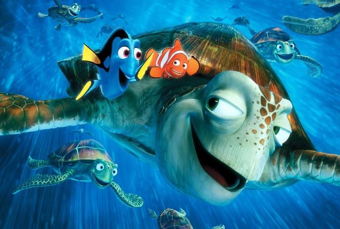 Turtles glide through ocean waters while a clownfish and a Pacific blue tang happily swim alongside them.