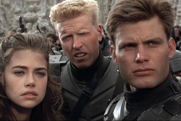 Three people staring straight ahead looking confused.