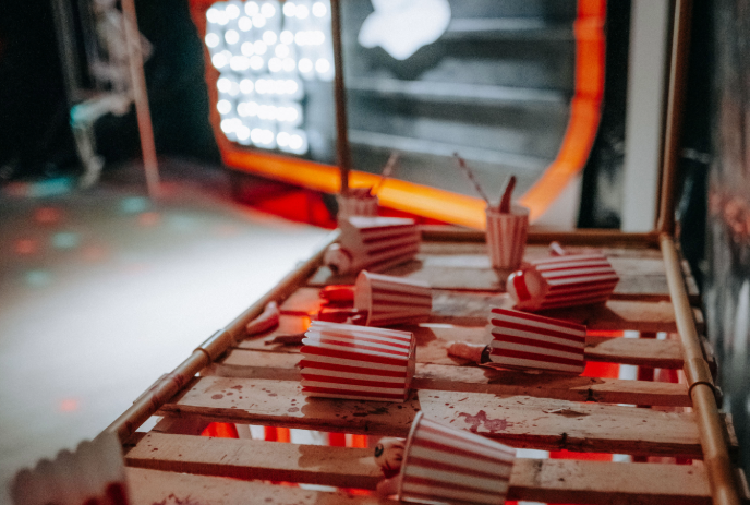 Spilled striped popcorn boxes on the table.