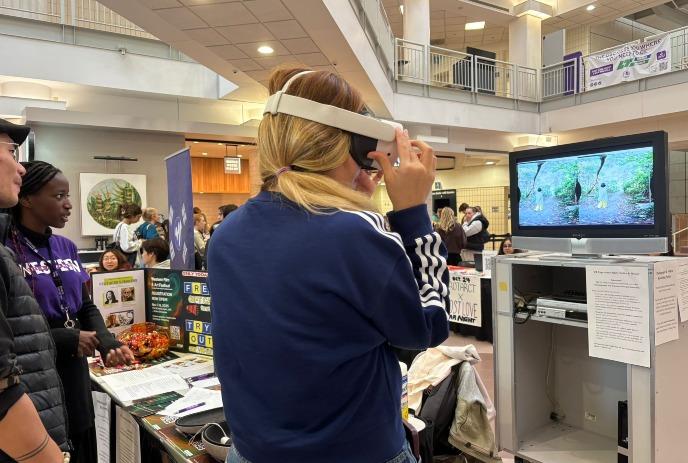 A person wearing a VR headset experiences an interactive display at an indoor event.