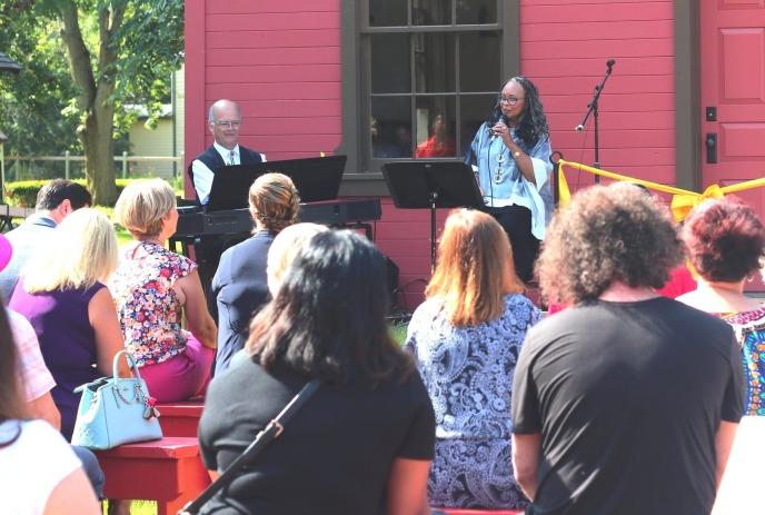Denise Pelley sings to a crowd of onlookers at a previous outdoor event.