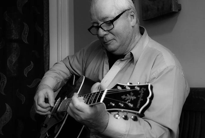 Jazz musician Larry Smith playing the guitar