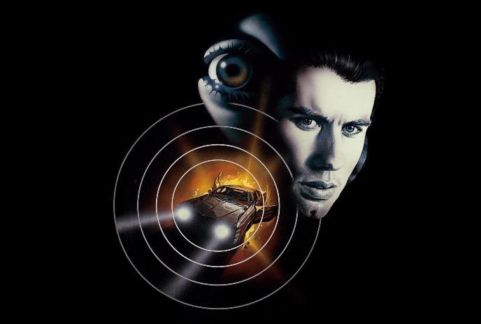 Man face with large eye behind and car in fiery blast centered in circle.