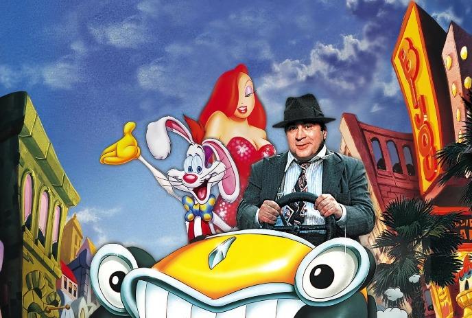 A man drives a lively cartoon car as two animated characters stand behind amid bright stylized buildings.