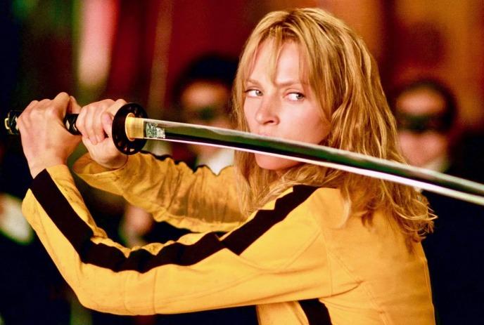 Uma Thurman wearing a yellow jacket, holding a sword in a picture from the movie Kill Bill.