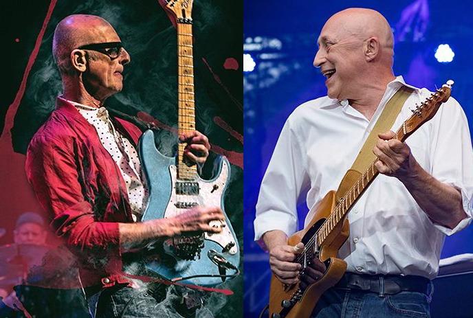 Two artists with electric guitars performing on the stage.