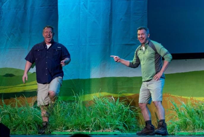 Chris and Martin Kratt smiling while performing on stage.