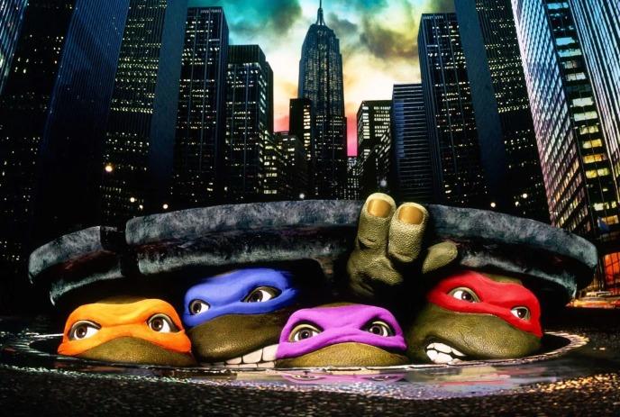 Teenage Mutant Ninja Turtles coming up from a sewer grate in New York City.