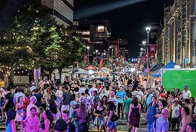 Crowds at Dundas Street with vendor tents and lively festival scene.