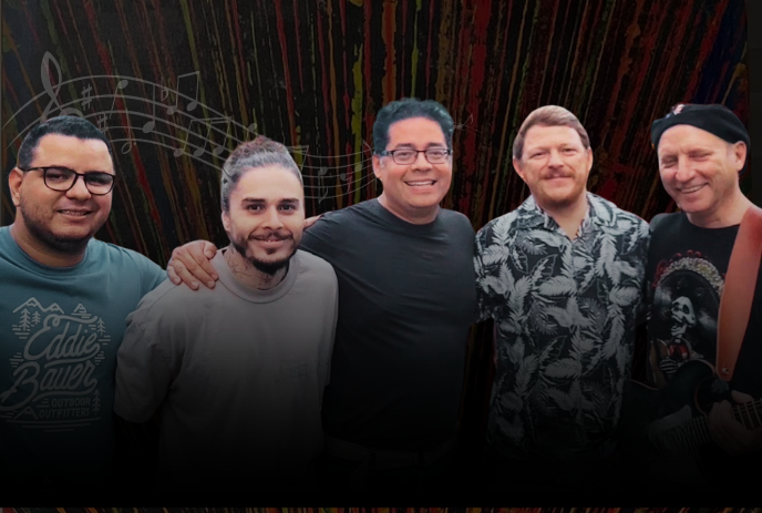 Five artists standing together before dark striped backdrop with musical note.