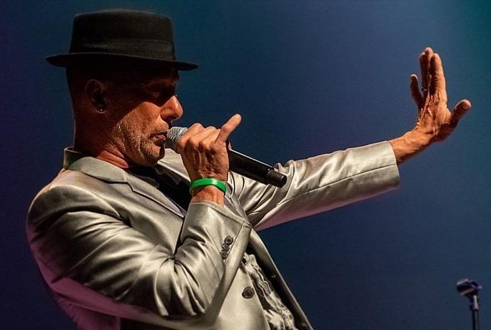 Multiple images of the tribute band performing onstage.