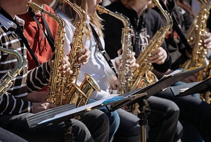 young musicians playing saxophones in an ensemble