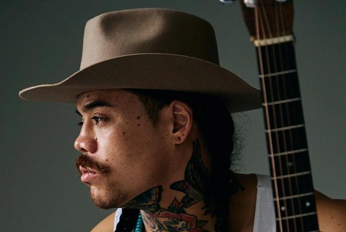 Two side-by-side portraits of Logan Staats looking up, dressed as a musician on the left and in Mohawk attire on the right.