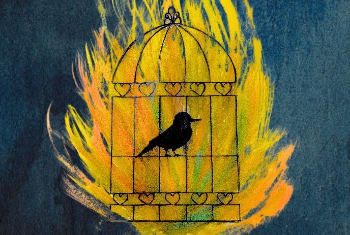 A black bird in a flaming yellow cage with hearts on a blue background.
