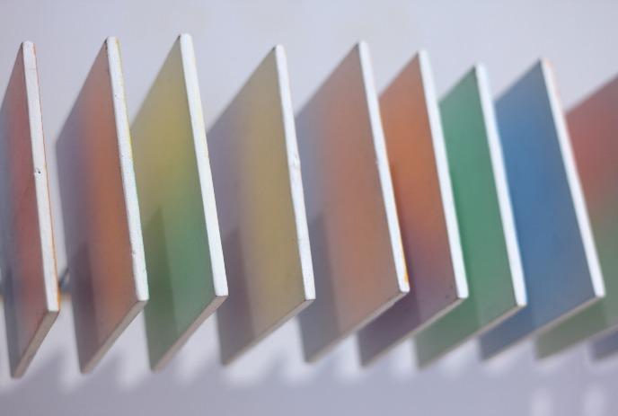 Diagonal row of gradient color panels shifting through warm and cool tones in a clean geometric layout.