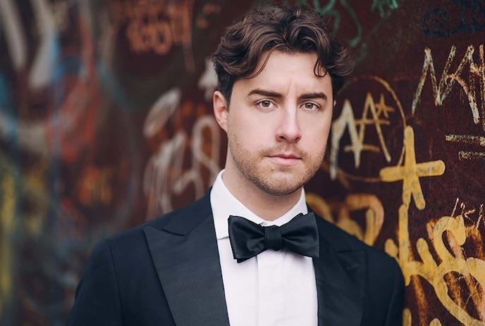 Portrait of a person wearing a tuxedo, looking directly at the camera.