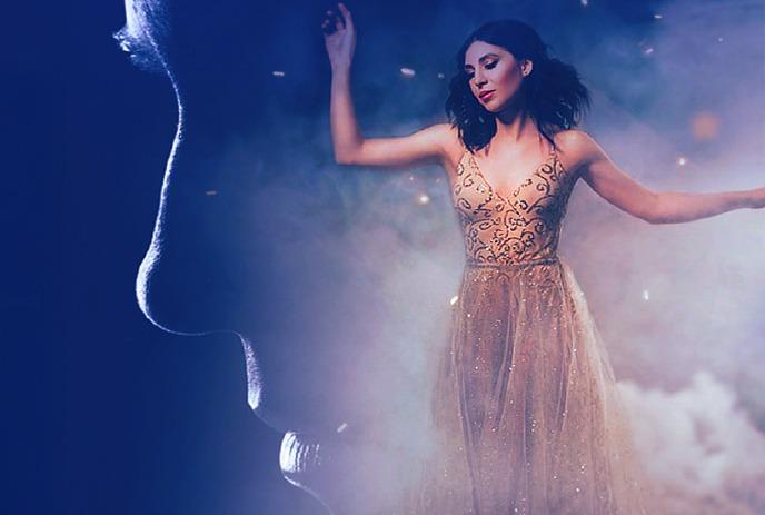 Shadowy profile of Andrew Lloyd Webber facing a woman in sparkling gold gown amid mist and stars.