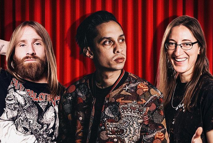Nick Reynoldson, Jason Allen and Kaitlin Shuvera posing in front of a red curtain.