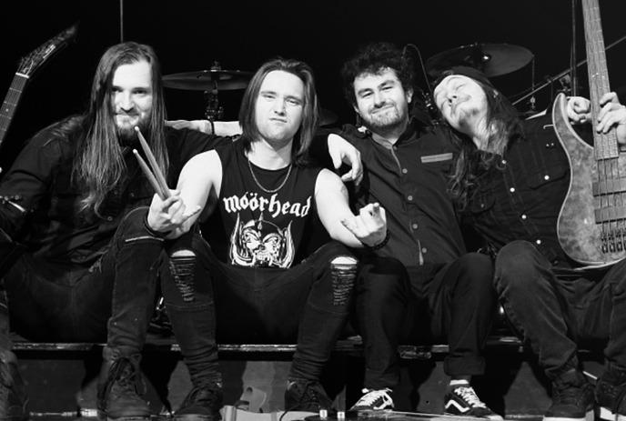 A black and white photo of the 4 band members of No Exceptions, posing together outside.