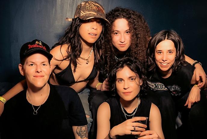 5 band members of the band NOBRO, posing together for the camera in front of a black background.