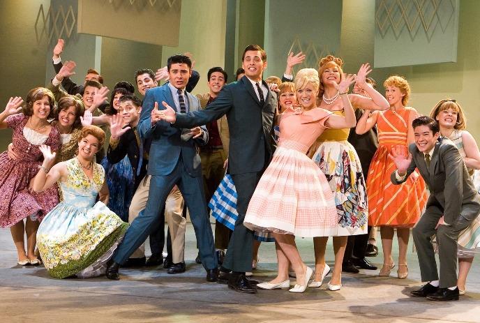 Large group of people dancing together in a ballroom.