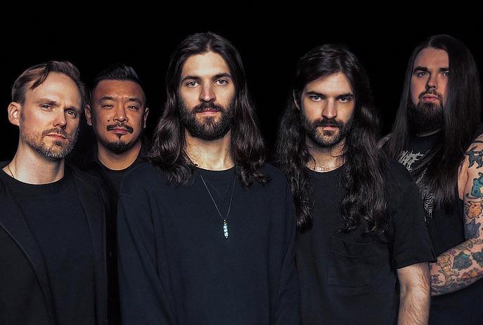 The members of Opal in Sky band standing next to each other in a line, all wearing black outfits, on a black background.